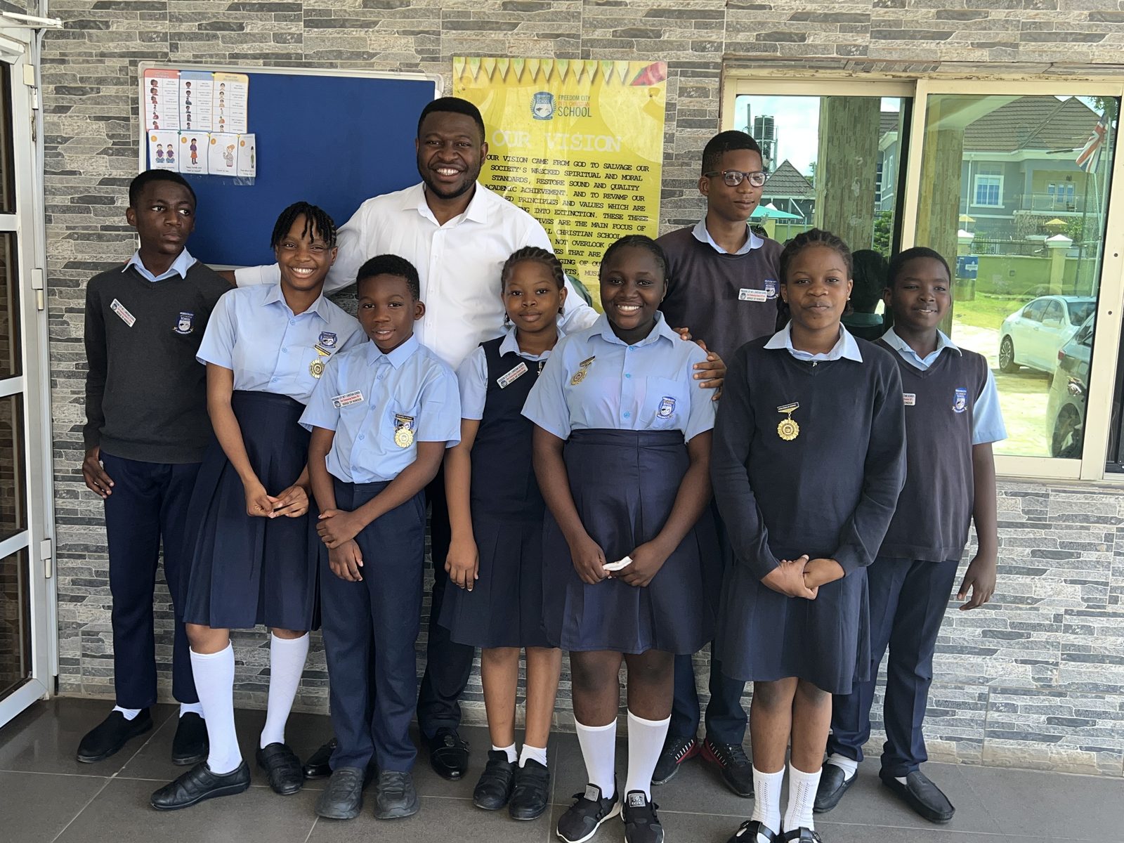 School director with students at Freedom City Int'l Christian School